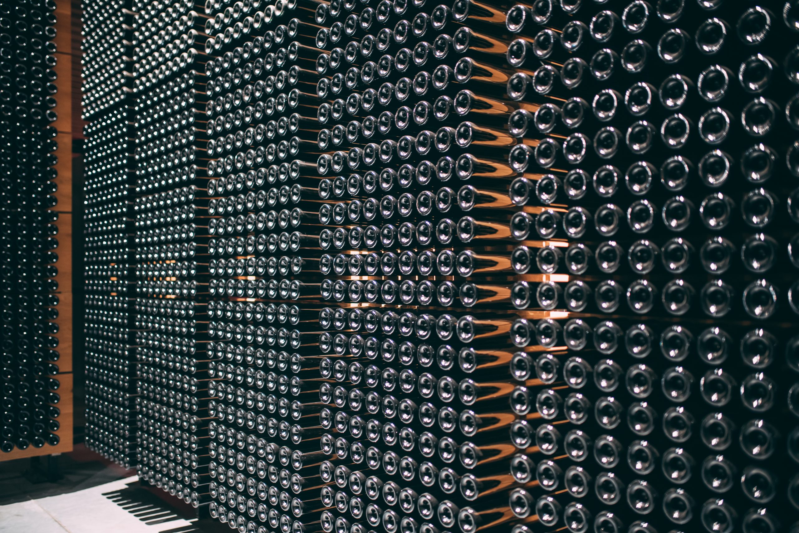 wine bottles stored in a winery on the fermentation process